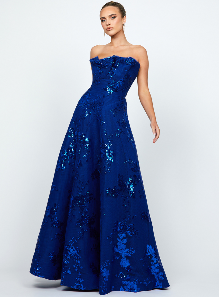 blue strapless gown with ruffle detail on neckline and flared a-line skirt for formal occasions