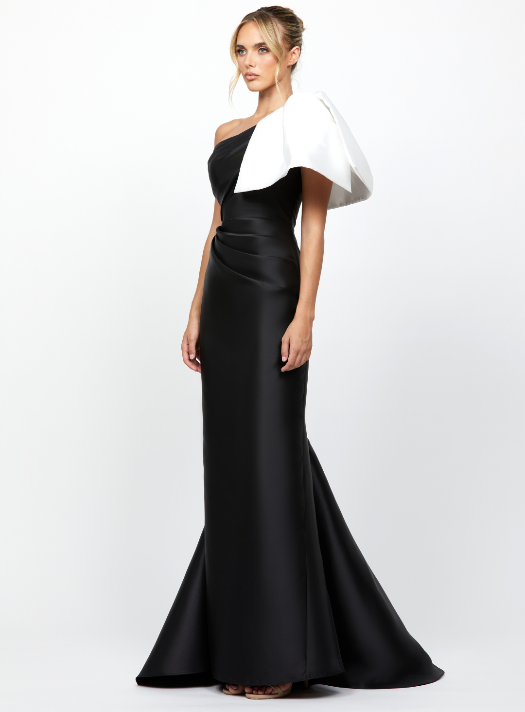 one shoulder black gown with dramatic white detailing on the shoulder